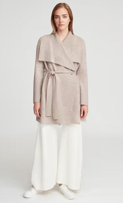 A woman wearing Cuyana wool cashmere sweater coat