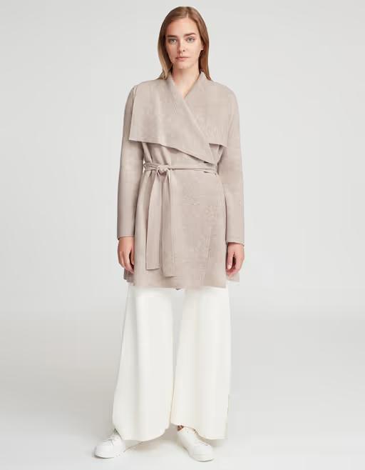 A woman wearing Cuyana wool cashmere sweater coat