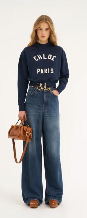 A woman carrying Chloé clay brown small paraty 24 bag in soft leather