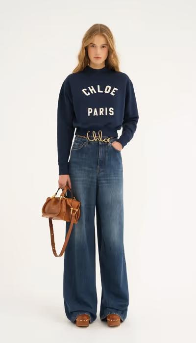 A woman carrying Chloé clay brown small paraty 24 bag in soft leather