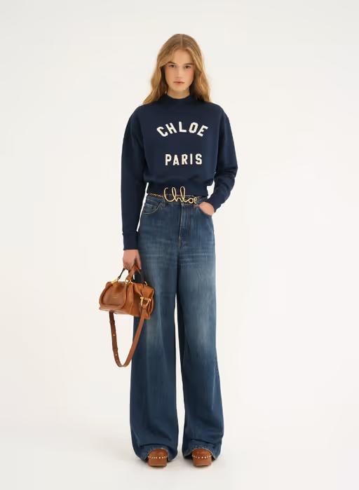 A woman carrying Chloé clay brown small paraty 24 bag in soft leather