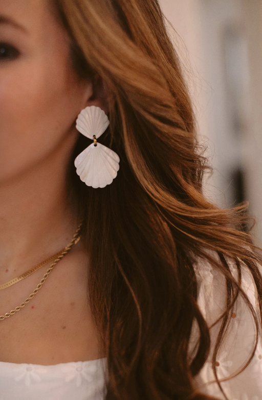 A woman wearing Brinker & Eliza caspia earrings