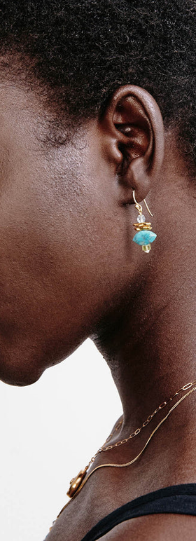 A woman wearing Chan Luu lisbeth drop earrings turquoise mix