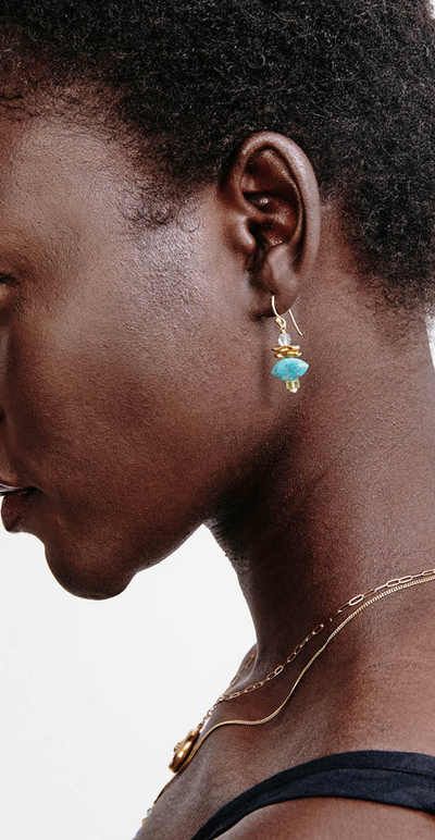 A woman wearing Chan Luu lisbeth drop earrings turquoise mix