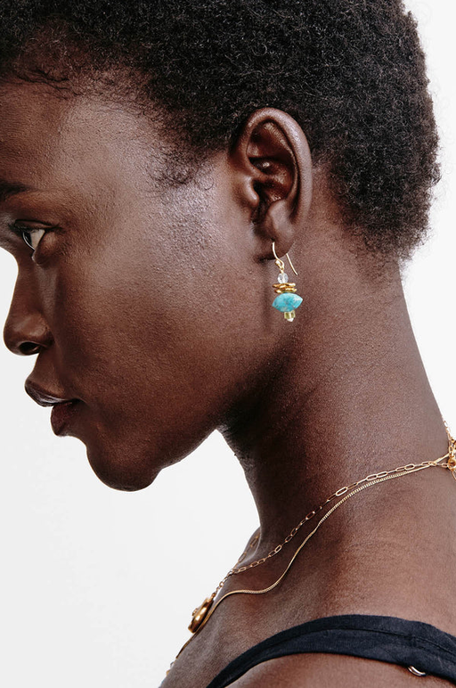 A woman wearing Chan Luu lisbeth drop earrings turquoise mix