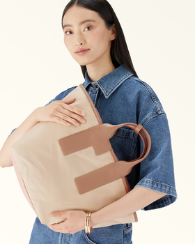 A woman carrying Furla piuma tote bag