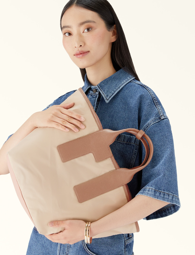 A woman carrying Furla piuma tote bag