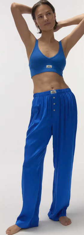 A woman wearing Love Stories silky pyjama pants
