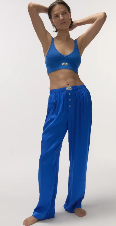 A woman wearing Love Stories silky pyjama pants