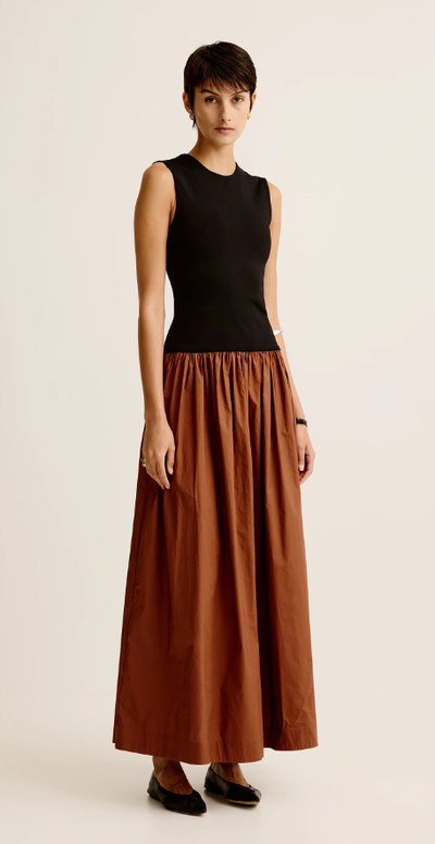 A woman wearing Esse Studios duo tank knit cotton dress - black / cinnamon