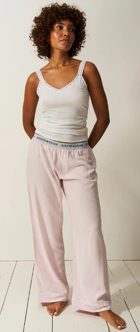 A woman wearing Stripe & Stare soft brushed woven pyjama bottoms