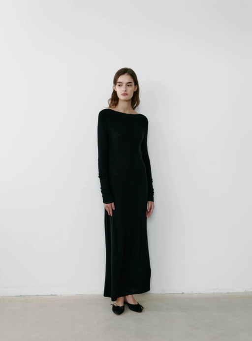 A woman wearing The Curated the resort dress - black