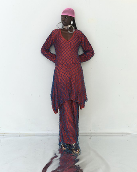 A woman wearing Tigra Tigra raw silk 'vampire in goa' net dress, maroon with jewel blue net