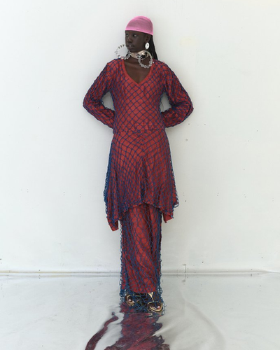 A woman wearing Tigra Tigra raw silk 'vampire in goa' net dress, maroon with jewel blue net