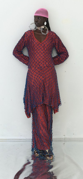 A woman wearing Tigra Tigra raw silk 'vampire in goa' net dress, maroon with jewel blue net