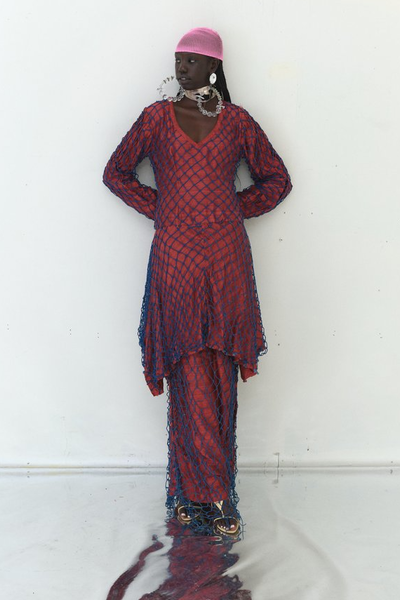 A woman wearing Tigra Tigra raw silk 'vampire in goa' net dress, maroon with jewel blue net