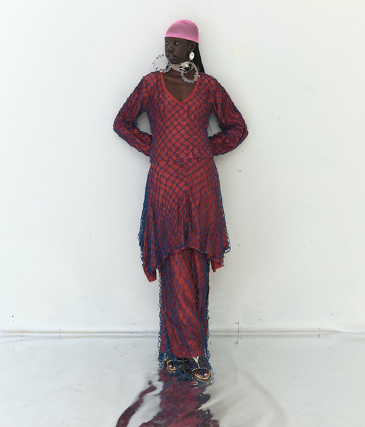 A woman wearing Tigra Tigra raw silk 'vampire in goa' net dress, maroon with jewel blue net
