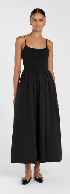 A woman wearing DISSH milano black cotton midi dress