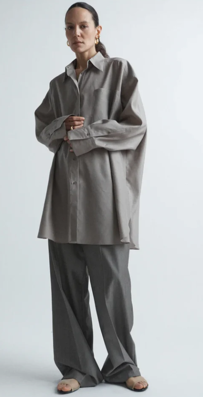 A woman wearing Raey oversized silk and wool shirt