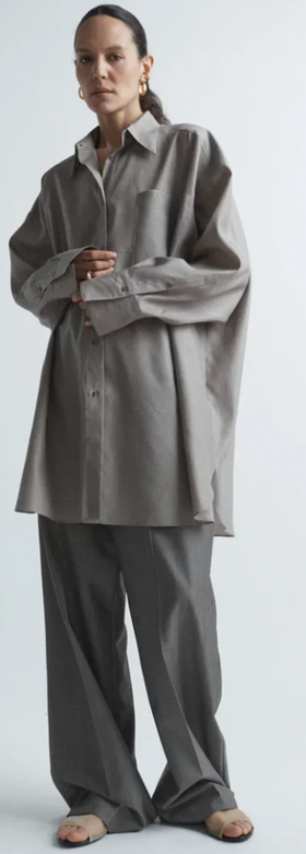 A woman wearing Raey oversized silk and wool shirt