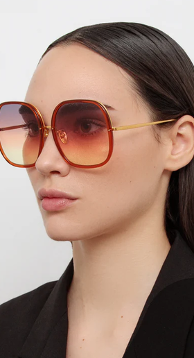 A woman wearing Linda Farrow celia oversized sunglasses in orange