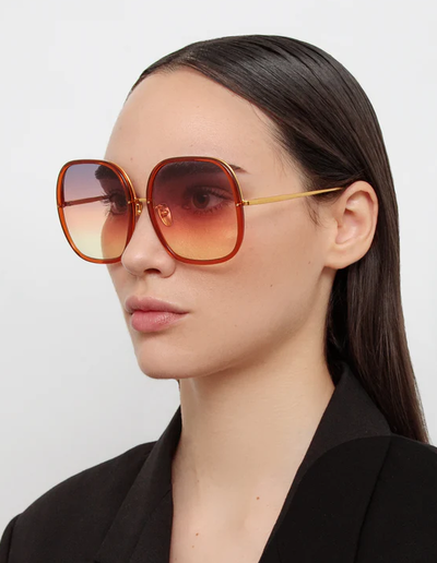 A woman wearing Linda Farrow celia oversized sunglasses in orange
