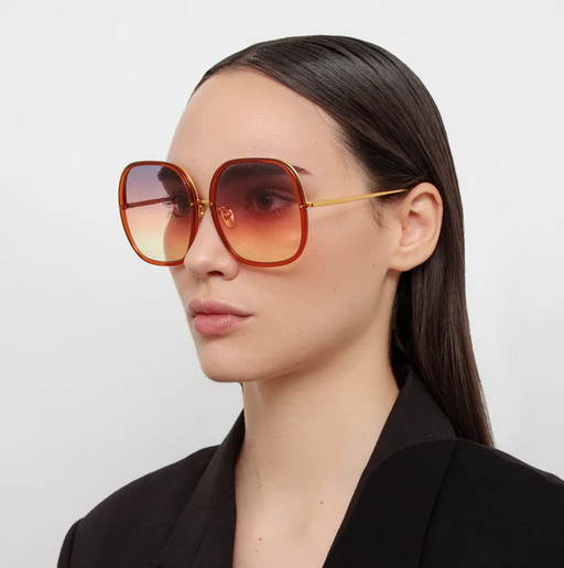 A woman wearing Linda Farrow celia oversized sunglasses in orange