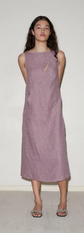 A woman wearing Deiji Studios high tie dress
