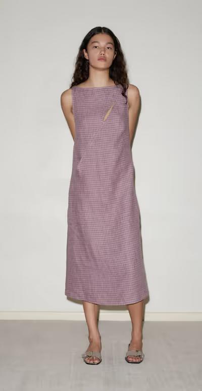 A woman wearing Deiji Studios high tie dress