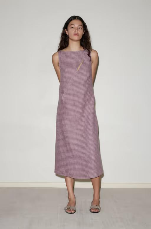 A woman wearing Deiji Studios high tie dress