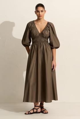 A woman wearing Matteau shirred plunge button dress