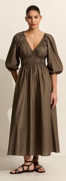 A woman wearing Matteau shirred plunge button dress