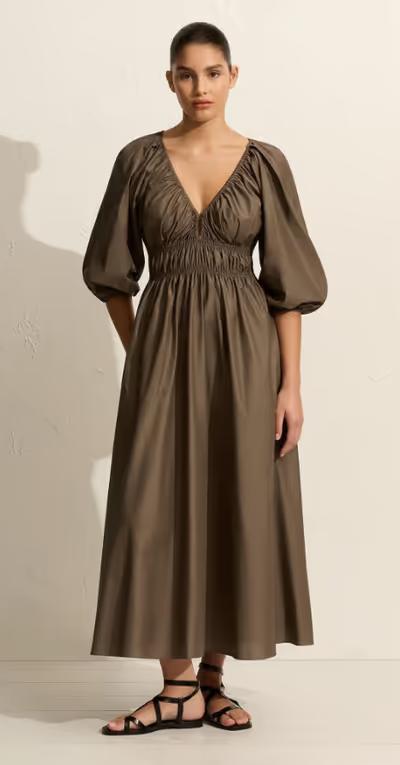 A woman wearing Matteau shirred plunge button dress