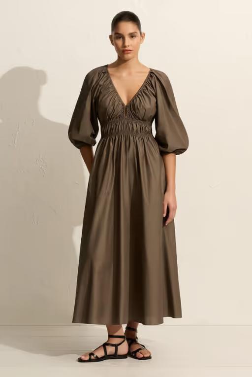 A woman wearing Matteau shirred plunge button dress