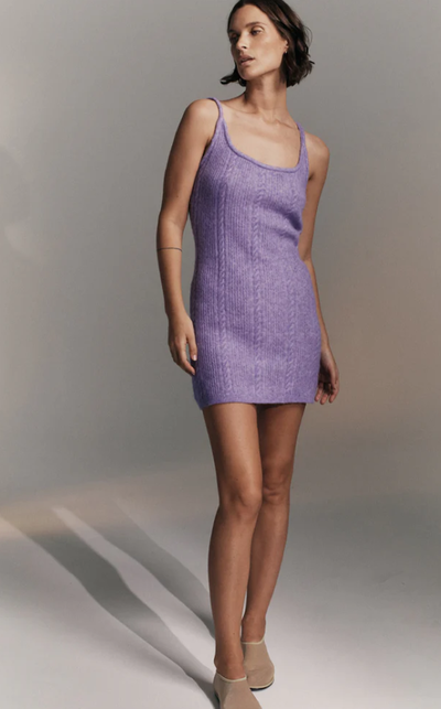 A woman wearing Nagnata iris color cable knit wool dress