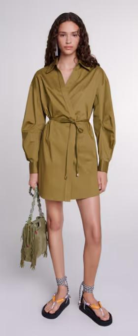 A woman wearing Maje khaki cutaway wrap dress