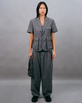 A woman wearing Bobblehaus bh zip-off wool suit pants