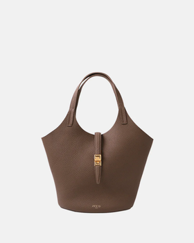A woman carrying Apede Mod etoupe togo small garden bag