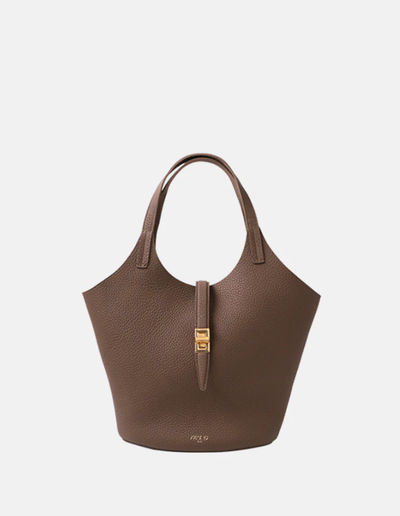 A woman carrying Apede Mod etoupe togo small garden bag