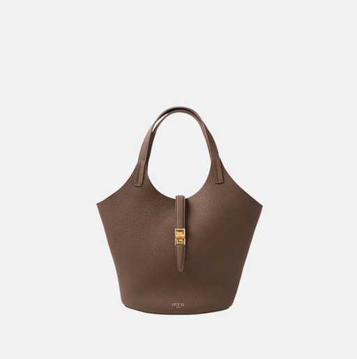 A woman carrying Apede Mod etoupe togo small garden bag
