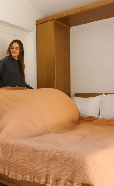 A woman with Sand Cloud lara dusty peach - party blanket™