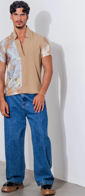 A man wearing orttu​ star neck shirt couture