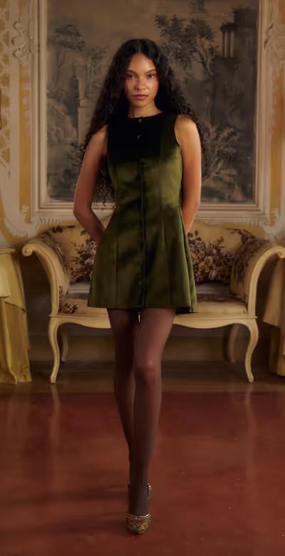 A woman wearing Mirror Palais verde velveteen dress