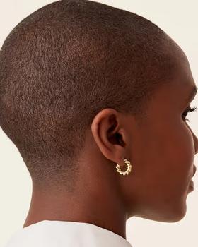 A woman wearing PAVOI rope hoops earrings