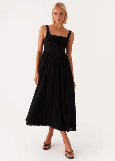 A woman wearing peppermayo peppermayo exclusive - pascuelle midi dress - black