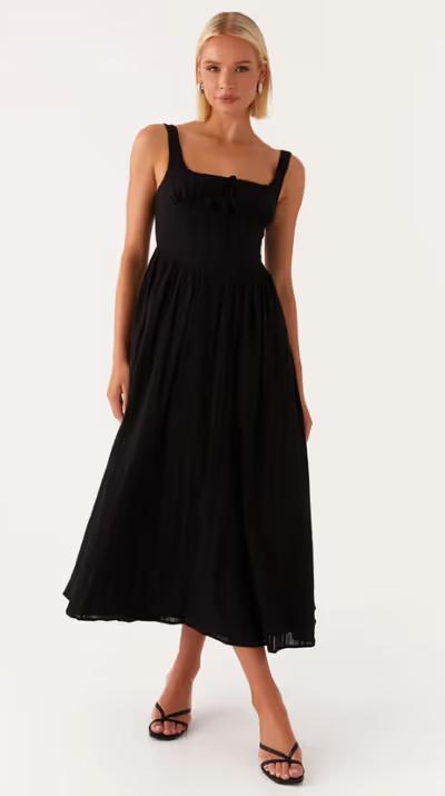 A woman wearing peppermayo​ peppermayo exclusive - pascuelle midi dress - black