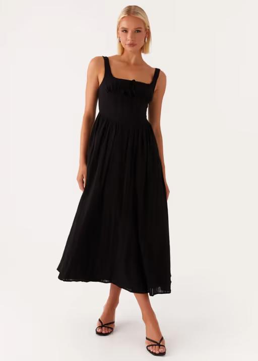 A woman wearing peppermayo peppermayo exclusive - pascuelle midi dress - black