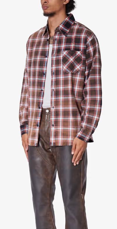 A man wearing mnml plaid orange flannel shirt