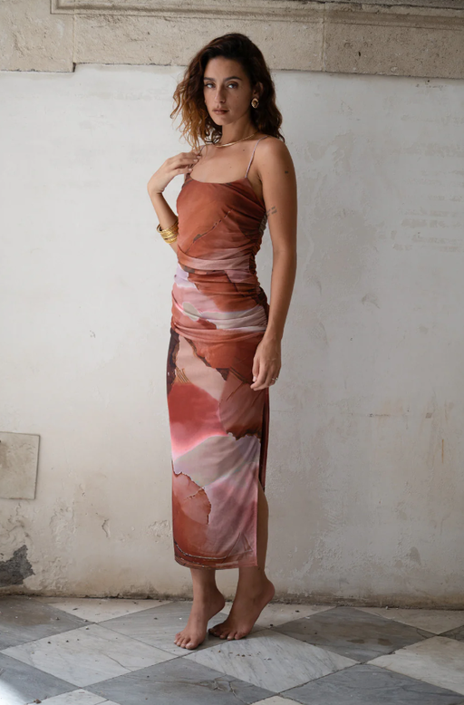 A woman wearing 12 Tribe caterina rust abstract mesh midi dress