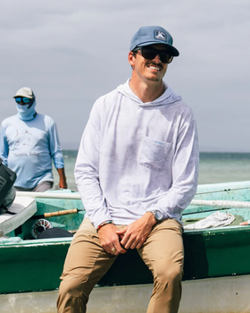 A man wearing Fish Hippie solmar performance hoodie